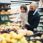 Shoppers checking a food package label against a recall notice on a phone