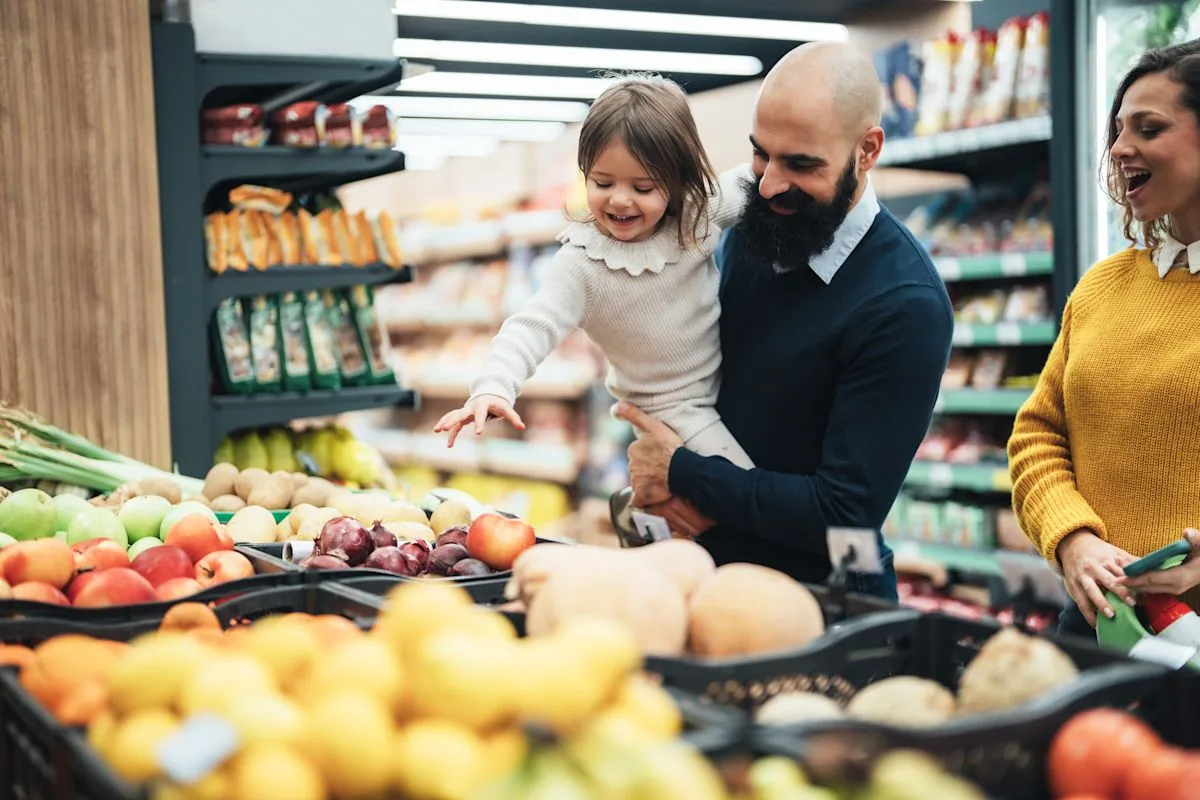 Shoppers checking a food package label against a recall notice on a phone